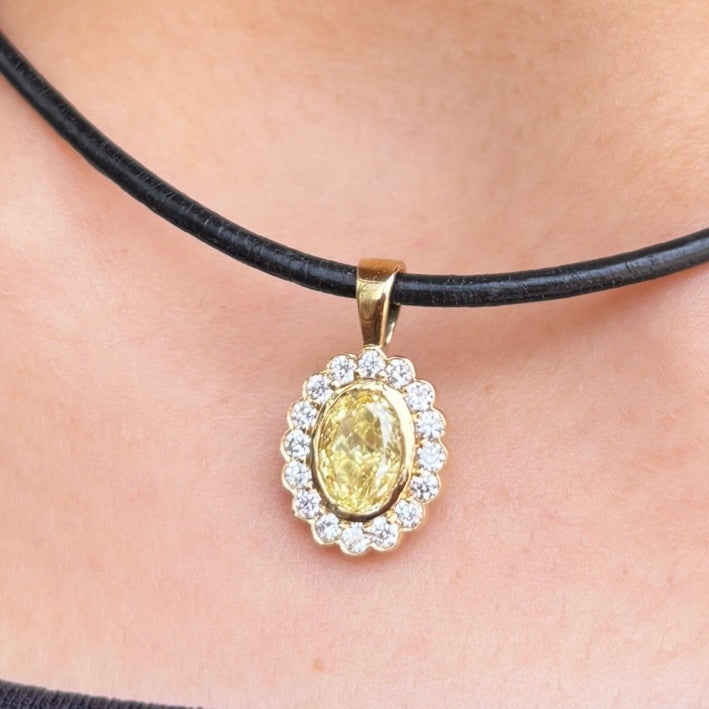 Marigold yellow diamond halo charm worn on a black cord