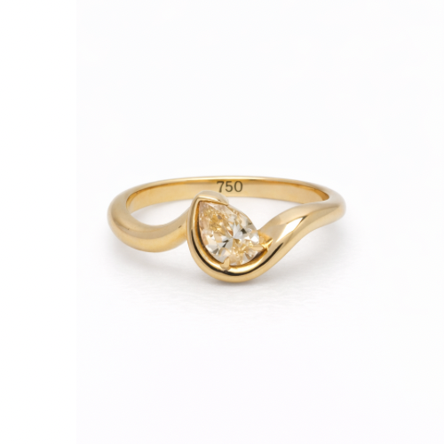 18K gold pinky ring with a bezel-set pear-shaped diamond.