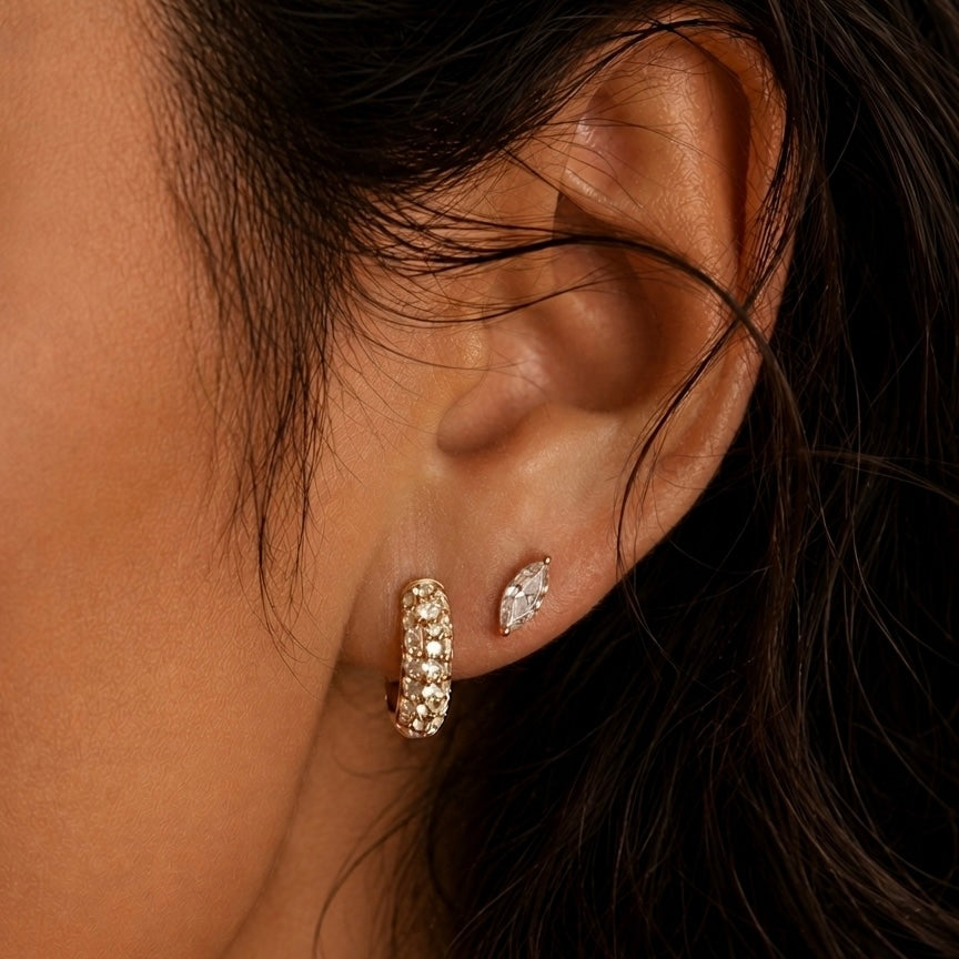 A model wearing diamond huggie earrings 