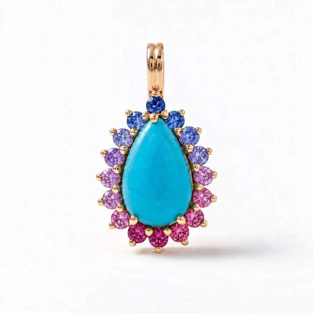 A gold pendant featuring a large teardrop-shaped turquoise center stone, surrounded by a halo of blue and pink gemstones, set against a plain white background.