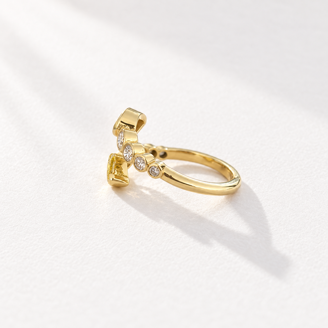 Afterglow 18K gold open bypass ring with bezel-set yellow and white diamonds, side view