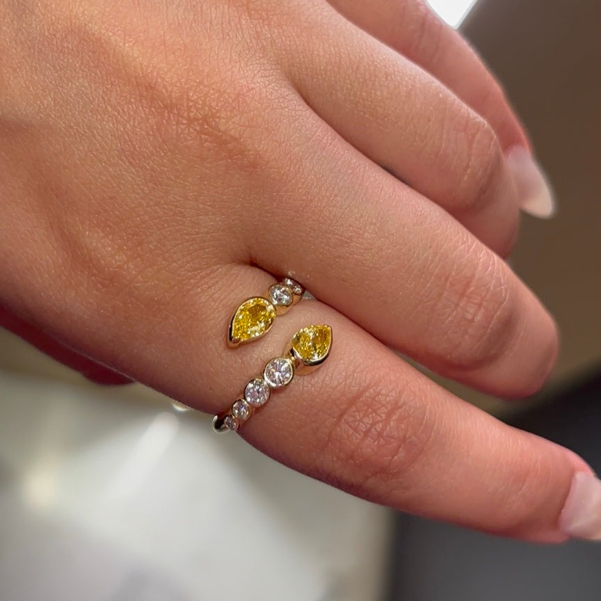Afterglow 18K gold half-bezel yellow pear and white diamond open ring worn on a hand