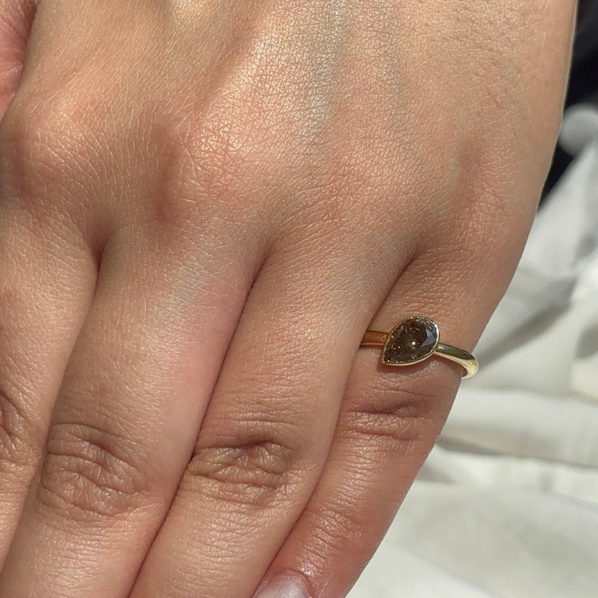 Ember one-carat lab-grown brown pear diamond ring worn on a hand