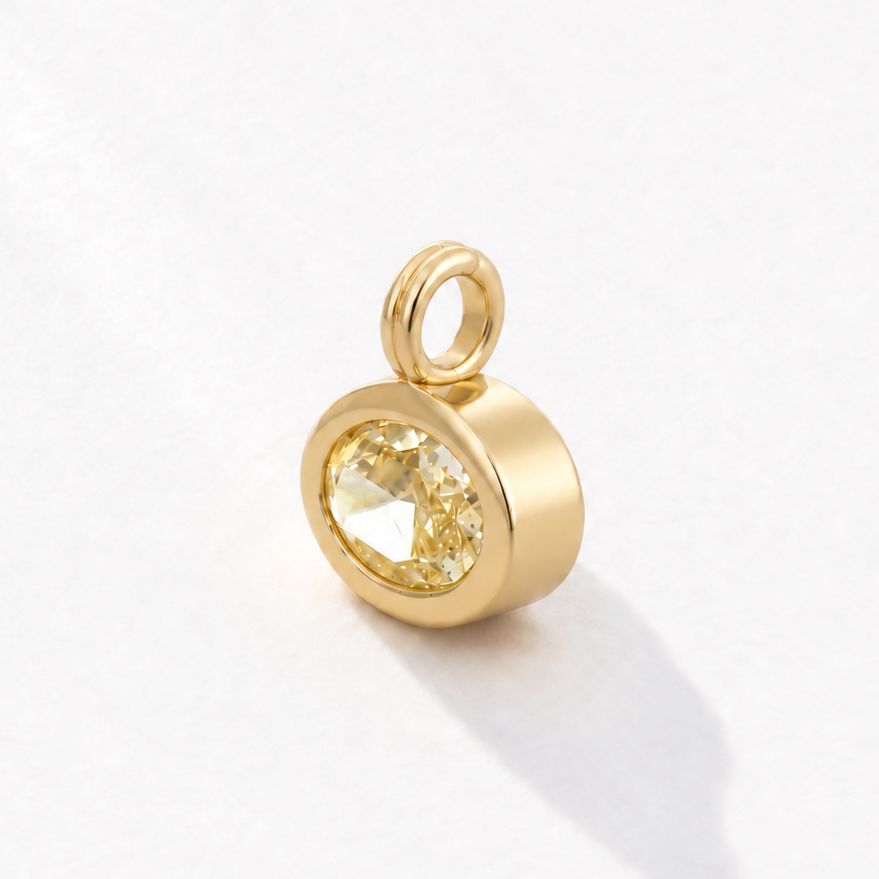Solstice 2 carat IGI-certified yellow oval diamond charm in 18K gold, three-quarter view