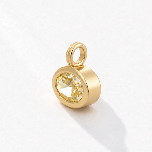 Solstice 2 carat IGI-certified yellow oval diamond charm in 18K gold, three-quarter view