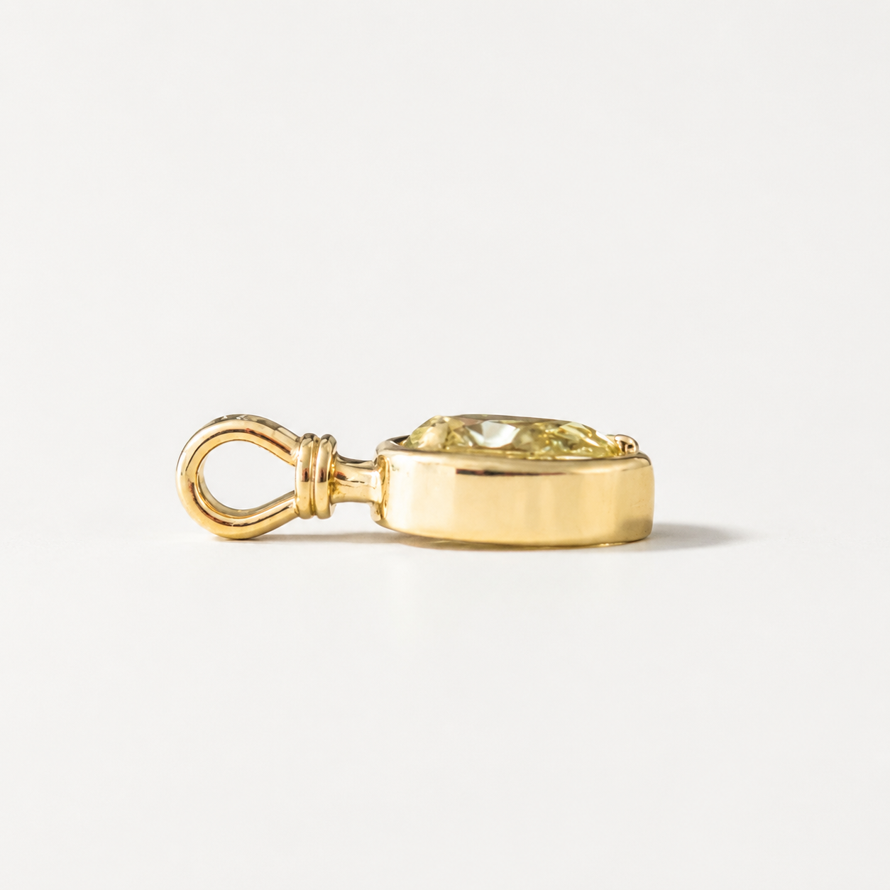 Side profile of Sundrop charm showing the yellow gold setting and bail.
