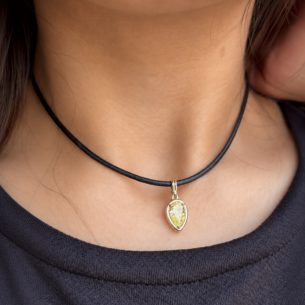 Sundrop 1.5-carat pear-shaped yellow diamond charm worn on a black cord; cord not included.
