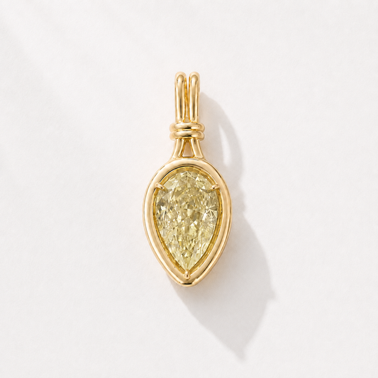 Sundrop 1.5-carat pear-shaped yellow diamond charm in polished gold on a white background.