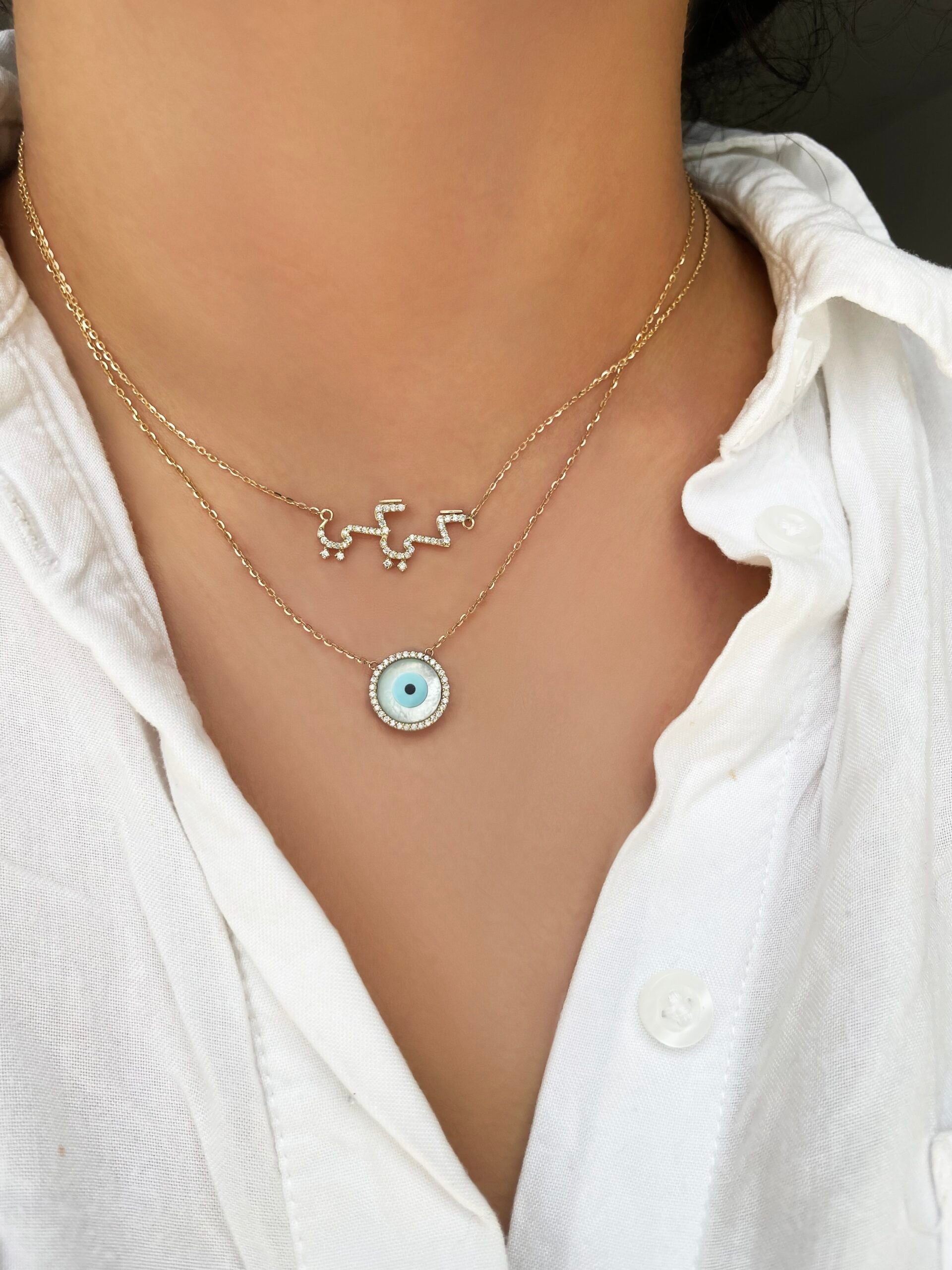 diamond arabic name necklace layered with a diamond mother of pearl evil eye necklace