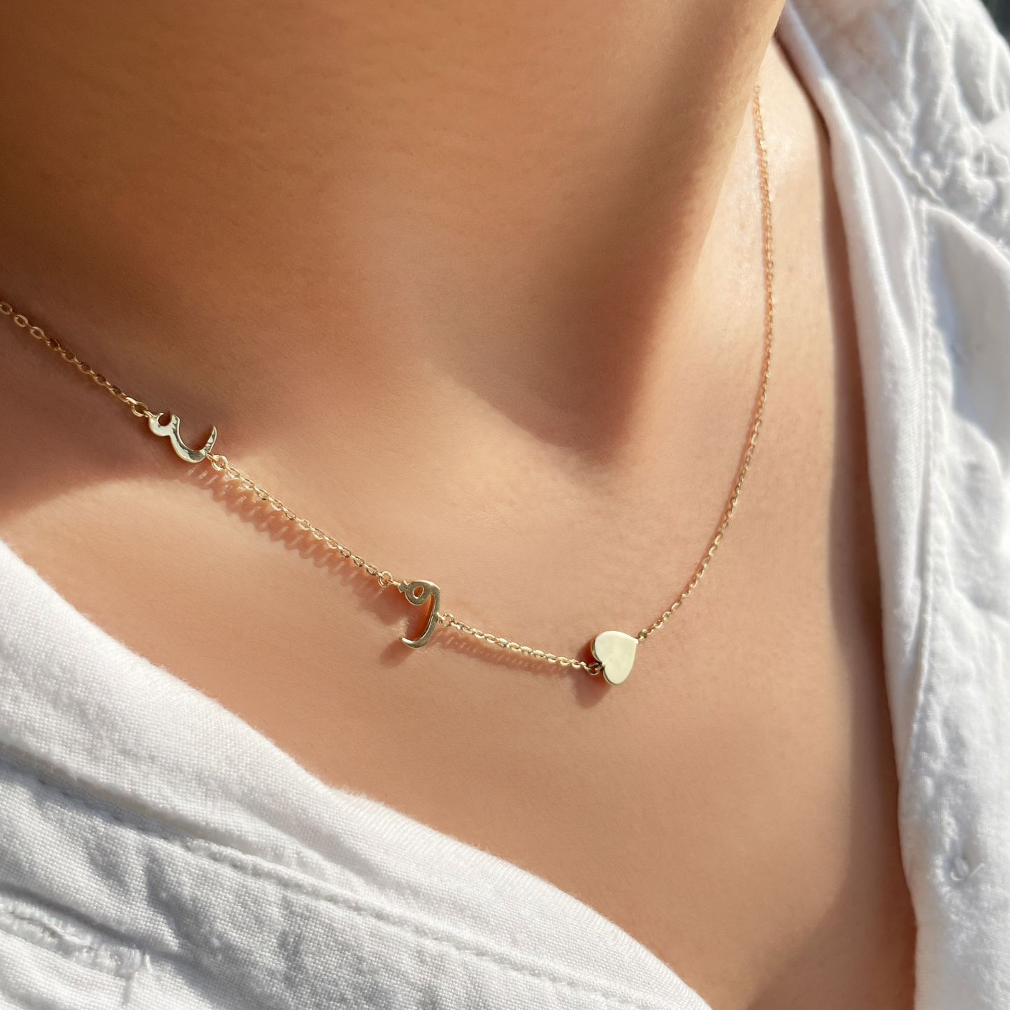 asymmetrical initial necklace in arabic. arabic initial charms with a heart. personalised necklace